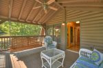 Ceiling fan and porch swing on covered deck.
